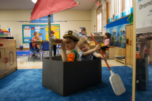Two boys at daycare participating in dramatic play
