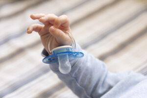 Baby holding pacifier