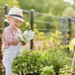 Young boy outside gardening